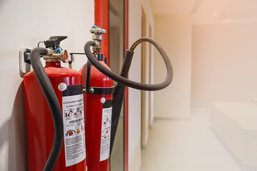 Fire extinguisher and gas pump system on the wall. Powerful emergency fire extinguisher equipment. Fire retardant. Fireproof.