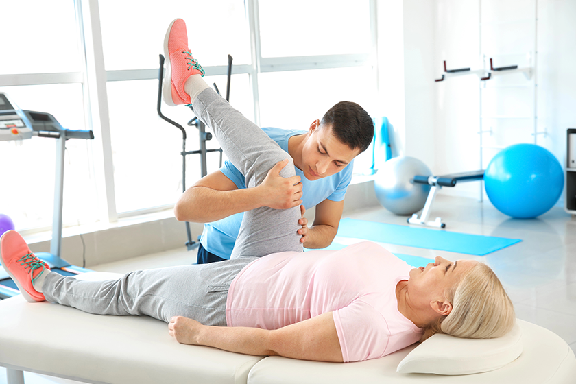 Physiotherapist working with mature patient in rehabilitation 